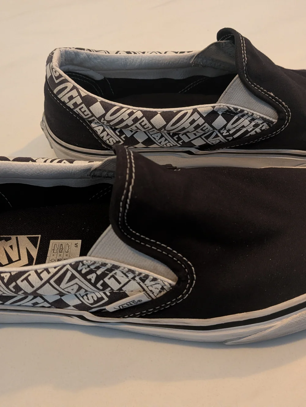 Vans Black Slip-On Sneakers with Classic Logo Accents